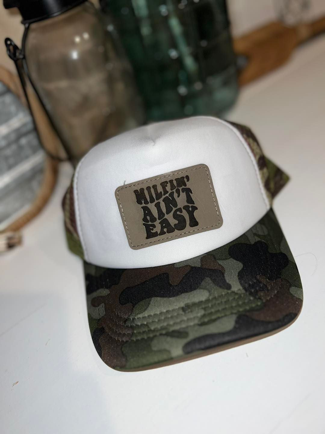 MILFN' AIN'T EASY TRUCKER HAT